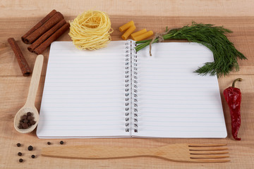 Baking ingredients for cooking and notebook for recipes on a woo