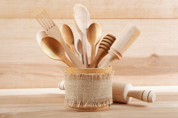 Set of kitchen utensils on wooden board.