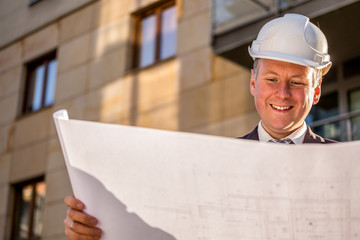 Construction manager with blueprints