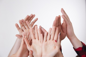 many hands reaching up