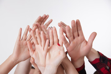 many hands reaching up