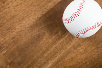 A baseball on wood table