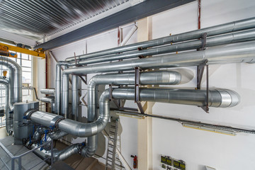 industrial boiler interior with lots of pipes and valves