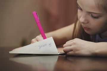 A girl writes a letter