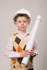 Boy in a construction helmet holding a drawing