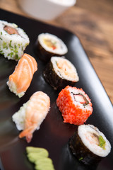 fresh Japanese tasty sushi roll set with chopsticks on wooden table