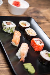 fresh Japanese tasty sushi roll set with chopsticks on wooden table