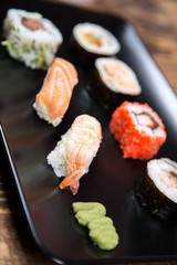 fresh Japanese tasty sushi roll set with chopsticks on wooden table