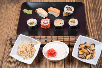 fresh Japanese tasty sushi roll set with chopsticks on wooden table