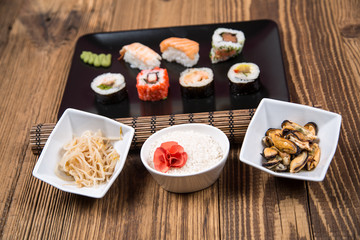 fresh Japanese tasty sushi roll set with chopsticks on wooden table