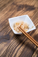 Fototapeta na wymiar Fresh platter of bean sprouts with chopsticks on wooden table