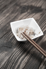 fresh Japanese tasty sushi roll set with chopsticks on wooden table