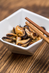 Fresh platter of mussel with chopsticks on wooden table