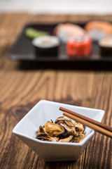 Fresh platter of mussel with chopsticks on wooden table