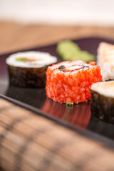 fresh Japanese tasty sushi roll set with chopsticks on wooden ta