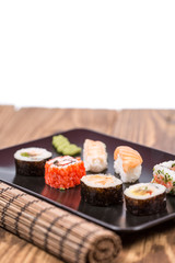 fresh Japanese tasty sushi roll set with chopsticks on table