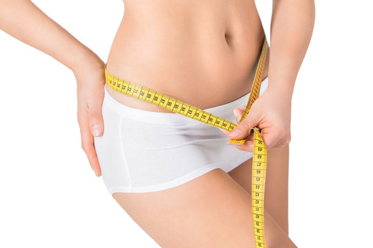 Woman measuring her waistline. Perfect slim body. 