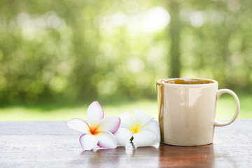 Coffee with flowers on wooden table