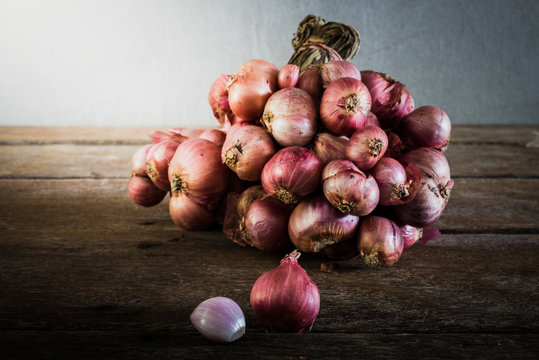 Shallot onions in a group on wooden table