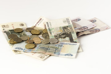 Some modern russian banknotes and coins on a white background