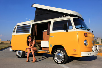 sexy woman sitting in a camper bus - roadtrip - obrazy, fototapety, plakaty