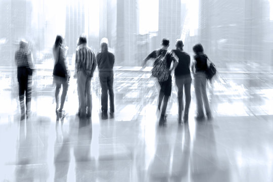 abstract image of people in the lobby of a modern business cente