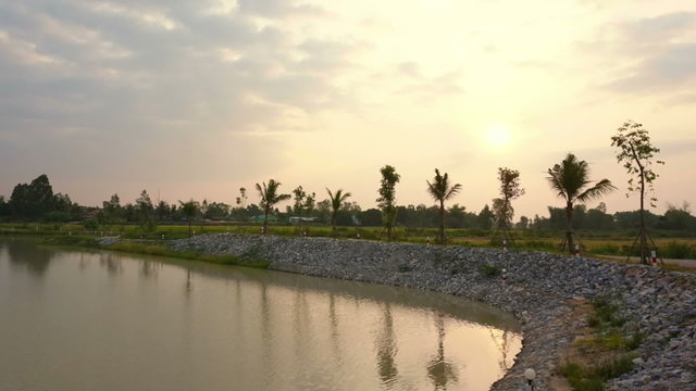 sunrise at lake, man made water reservoir with rice field 