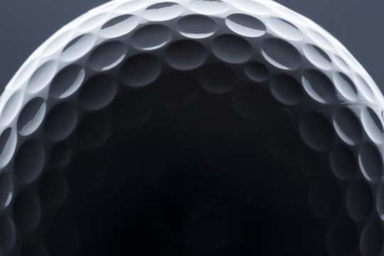 Macro Shot Of Golf Ball With Light And Shadow.