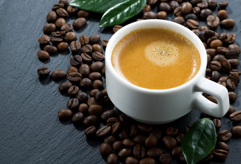 cup of espresso on coffee beans background, horizontal