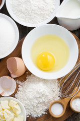 prepared fresh baking ingredients on a wooden board, top view