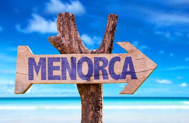 Menorca wooden sign with beach background