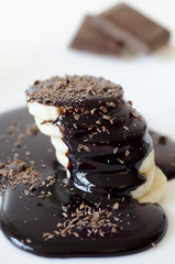 Slices of banana with poured chocolate and chocolate bars