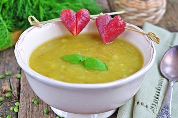 Appetizing pea soup with bacon and sausage