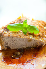 Bright photo of baked meat with basil leaf