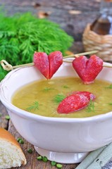 Appetizing pea soup with bacon and sausage