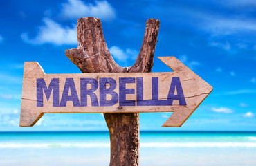 Marbella wooden sign with beach background