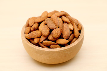 Fresh almonds in a wooden bowl