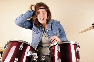 Fototapeta na wymiar Studio shot of a young lady on drums