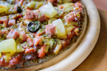 pizza Hawaiian thin crust pizza.