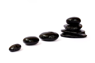 Black wet stones on white background