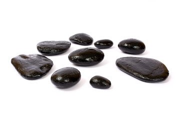 Black wet stones on white background
