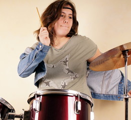 Studio shot of a young lady on drums