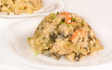 A plate of a Russian salad with shrimps