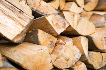 Fototapeta premium Dry chopped firewood logs ready for winter. Selective focus