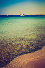 View of the yacht on Red Sea and the rocky coast.