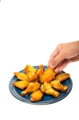 roasted chicken wings  with man hand