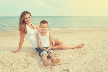 Mother and her son having fun on the beach