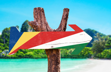 Seychelles Flag wooden sign with beach background