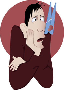 Nasal congestion. Man with a clothespin on his nose