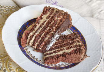 Sweet chocolate cake with cream on a plate